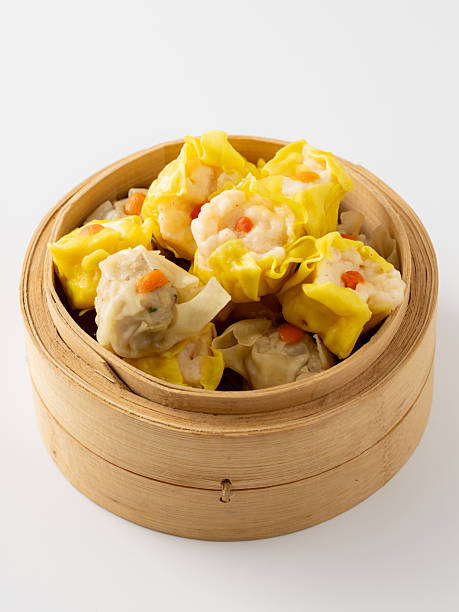 istock Delicious Steamed Dumplings in a Bamboo Basket Perfect for Sharing 2237126547