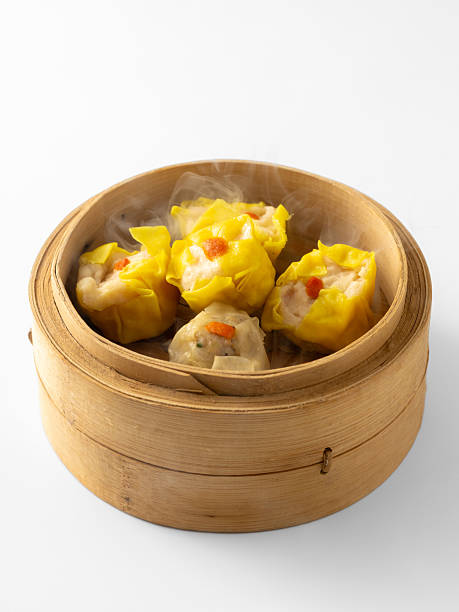 istock Steaming Dumplings in Bamboo Steamer on White Background 2237126657
