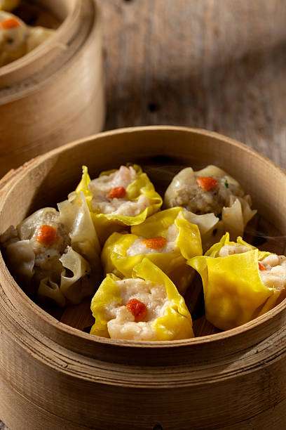 istock Freshly Steamed Dumplings in Bamboo Steamer on Rustic Wooden Surface 2237126681