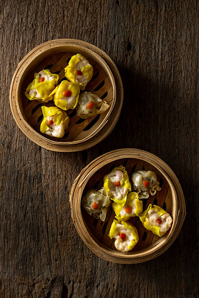 istock Freshly Steamed Dumplings in Bamboo Baskets on Rustic Wooden Table 2237126723