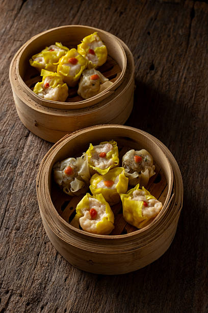 istock Steamed Dumplings in Bamboo Baskets on Rustic Wooden Surface 2237126746