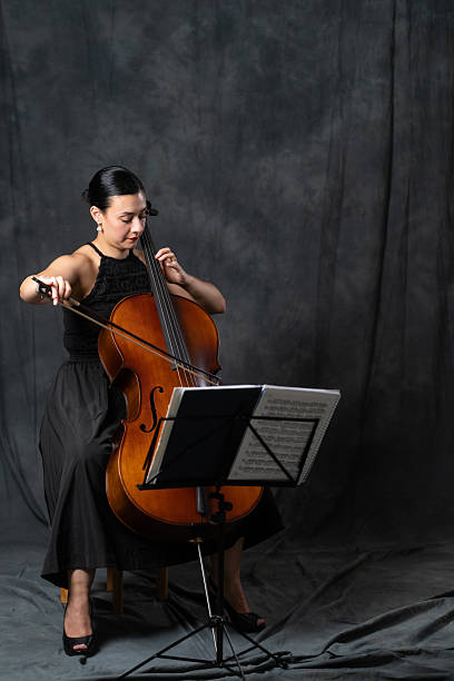 istock Female Cellist Playing Cello with Music Stand 2237128953