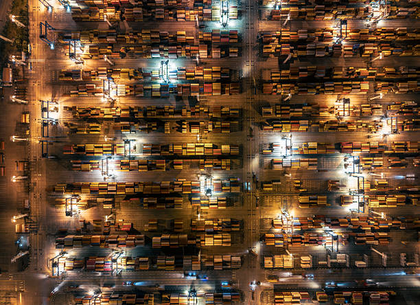 istock Busy container terminal with colorful cargo boxes illuminated at night. 2237130381
