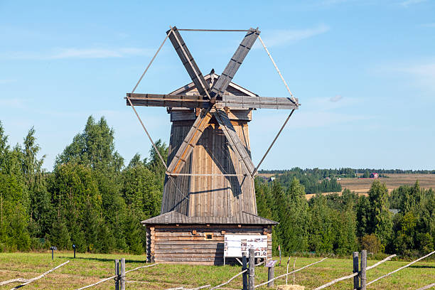 istock Historic Wooden Windmill with Large Blades under Blue Sky 2237133817