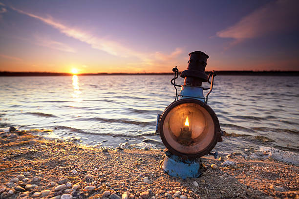 rustic old lantern on the beach in autumn season