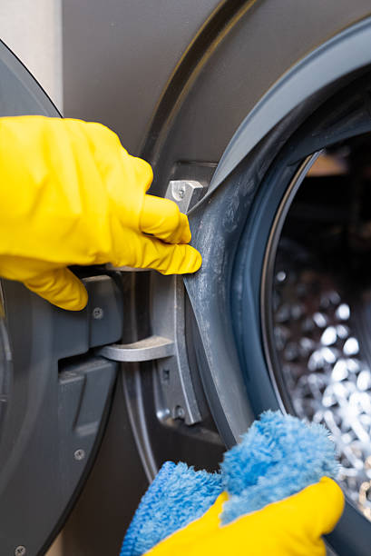 istock Cleaning washing machine drum with gloves 2237138446