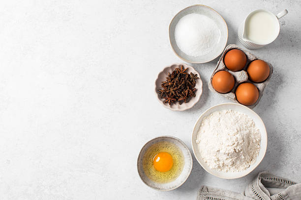 istock Baking ingredients flat lay with flour, eggs, sugar, and spices on marble surface. Copy space 2237138644