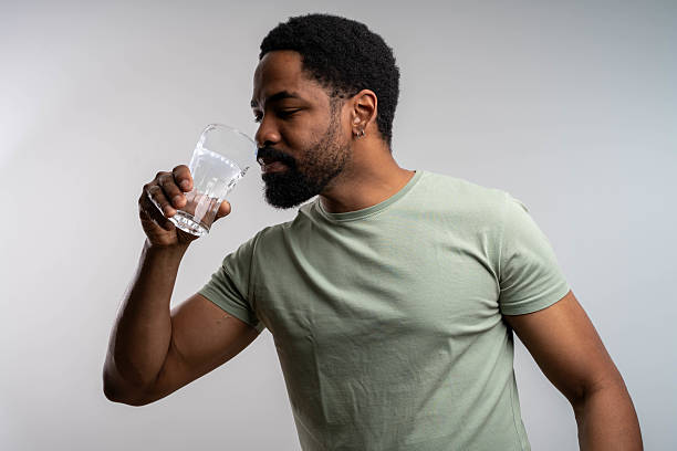 istock Black man drinking water isolated on white background wellness 2237139470