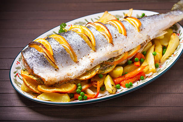 istock Roasted salmon with lemon, oranges and herbs served with vegetables 2237141121