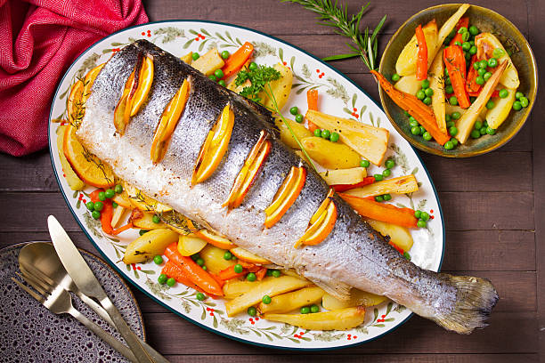 istock Roasted salmon with lemon, oranges and herbs served with vegetables 2237141143