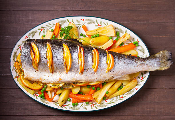 istock Roasted salmon with lemon, oranges and herbs served with vegetables 2237141158