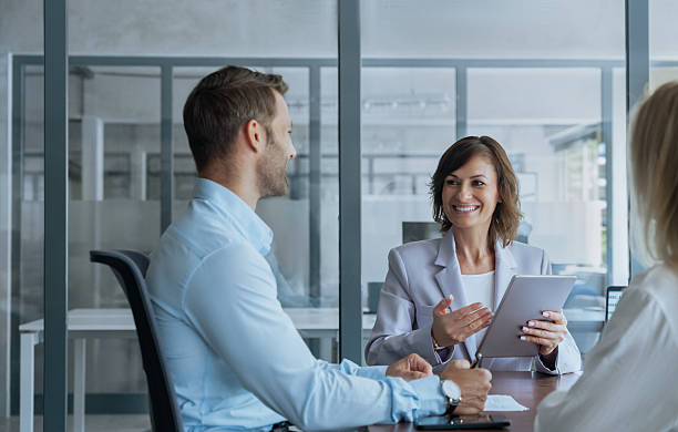 istock Professional business people working together using technology having meeting. Team mature ceo businesswoman mentor discussing project with young european colleagues man and woman on tablet at office 2237141517