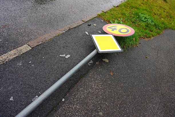 A 40 kilometres per hour speed sign has been run over in a traffic accident leaving shattered glass on the ground.
