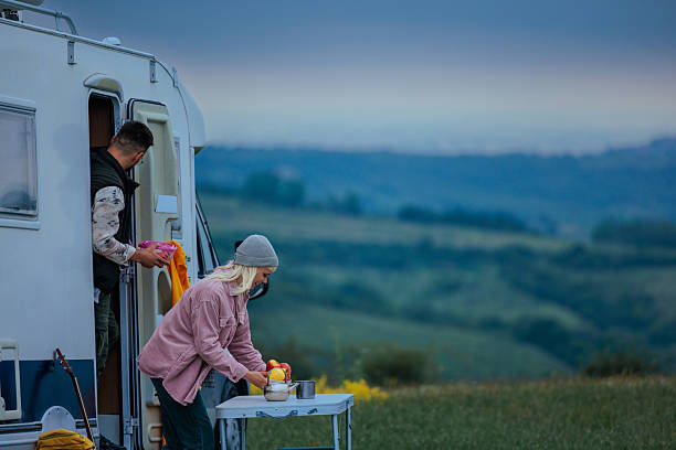 istock Two people setting the table for breakfast next to an RV 2237144464