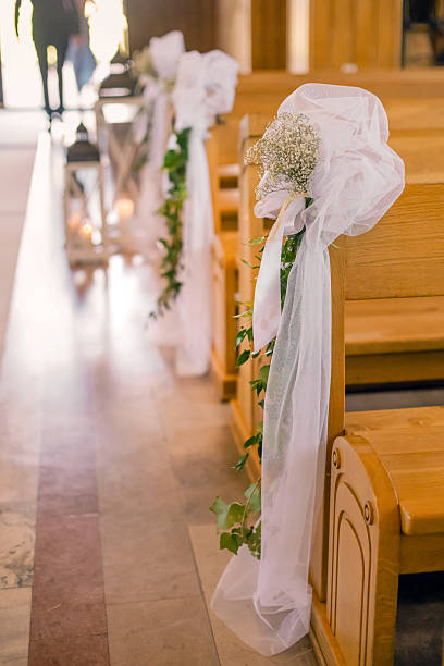 istock Floral wedding church pew decoration with roses, carnations and greenery 2237145921