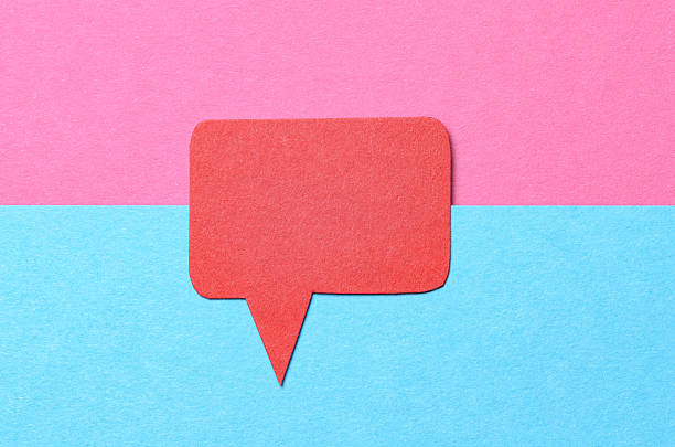Red blank cut out paper speech bubble with copy space for text on pink blue background, flat lay top view conceptual backdrop