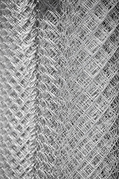 istock Chain link fence material rolled up as background 2237149777