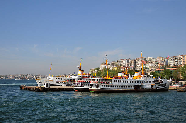 Dolmabahçe, Beşiktaş district, Istanbul, Turkey: the vapur ferries of Istanbul, operated by Şehir Hatları (City Lines), form a historic and iconic part of the city’s public transport network, serving routes across the Bosphorus, the Golden Horn, and the Princes’ Islands. Originating in 1851 under the name Şirket-i Hayriye, the service is today managed by Şehir Hatları A.Ş., a subsidiary of the Istanbul Metropolitan Municipality. The fleet, consisting of around 30 vessels, carries nearly 40 million passengers annually, with more than 900 sailings each day linking 53 piers. Beyond their essential role in daily commuting, vapur ferries are a cultural symbol of Istanbul, offering scenic journeys that highlight the city’s maritime heritage.