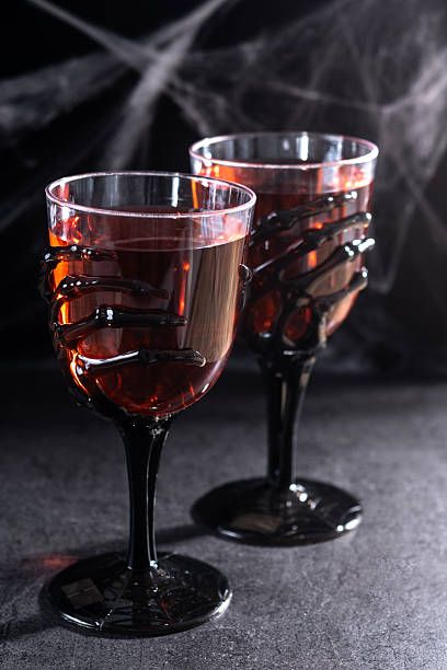 istock Halloween spooky red cocktail in skeleton hand glass 2237156390