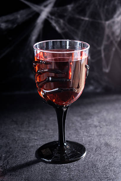 istock Halloween spooky red cocktail in skeleton hand glass 2237156566