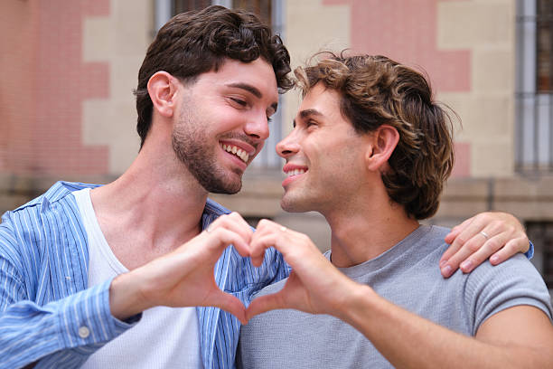A portrait of happy couple having fun outdoors, showing their love, kissing themselves.
