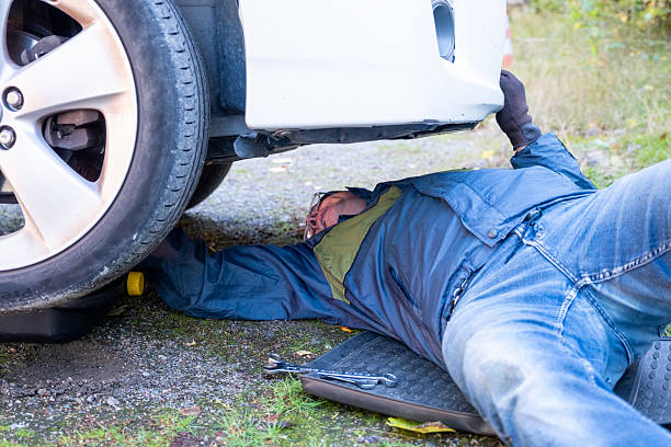 istock A Caucasian man is lying under a car, changing engine oil. 2237167712