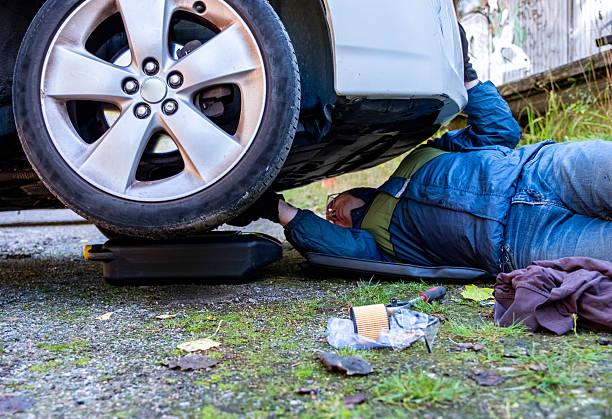istock A Caucasian man lies under a car, changing engine oil and filter. 2237168461
