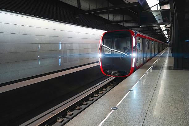 istock A sleek, modern train approaches an underground station, illuminated by bright lights. The station features shiny tiles and a clean platform, reflecting a contemporary urban environment 2237179562