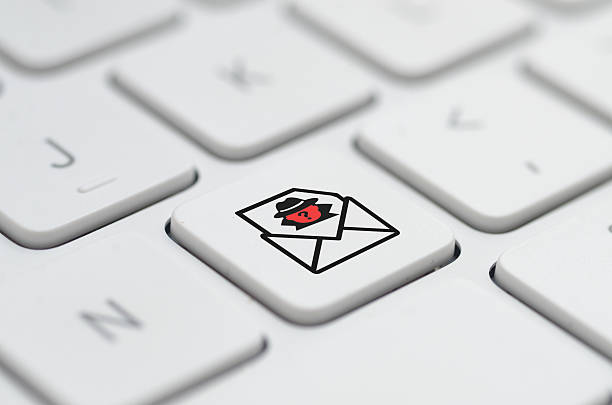 istock a customized key with a red spy-in-envelope icon, serving as a stark warning against phishing scams and malicious emails. 2237183753