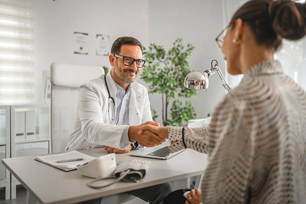 istock Doctor shaking patient hand during office consultation 2237183770