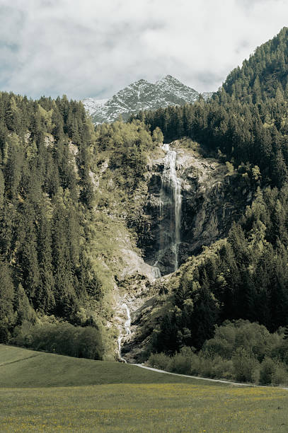 dramatic view on the big staubifall waterfall in alps. travel and hiking concept