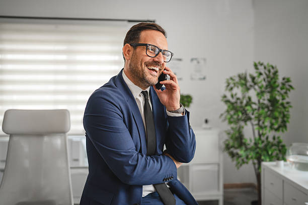 istock Happy businessman talking on phone in modern office 2237184475