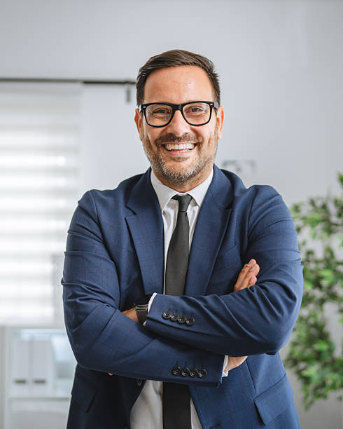 istock Confident smiling businessman standing arms crossed in office 2237184632