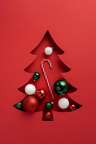 istock Festive vertical Christmas card featuring a stylish tree cutout with ornaments and candy canes 2237187065