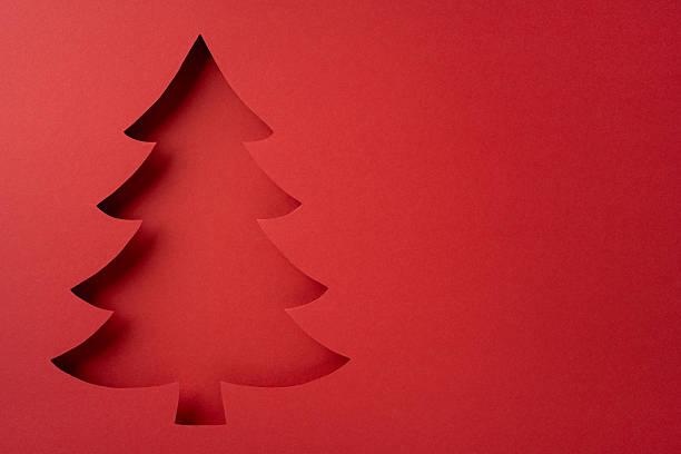 istock Stylish festive image of a Christmas tree cutout with a bright red backdrop capturing the holiday spirit 2237187071