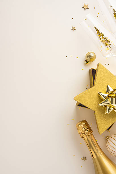 istock A festive vertical arrangement featuring a champagne bottle, golden decorations, and celebratory confetti. Perfect for showcasing holiday or New Year celebrations with elegance and style 2237187081