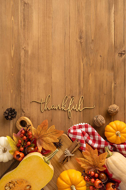 istock Vertical view featuring a wooden background adorned with Thanksgiving and harvest-themed decorations 2237187135