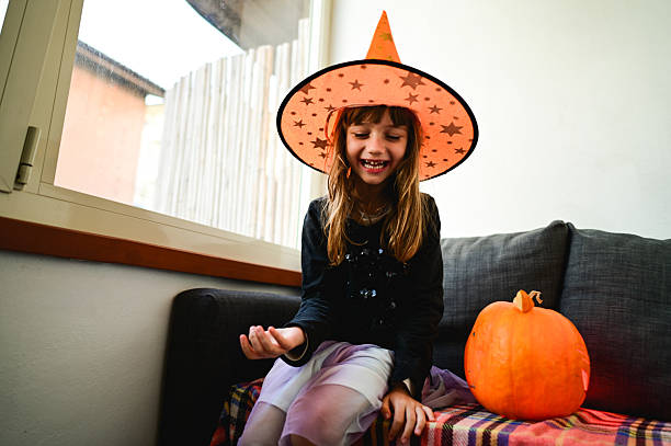 Family having fun at home with decorating for Halloween night