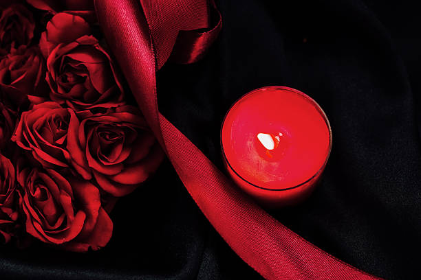 istock Romantic candle and red roses create a lovely setting for a special evening 2237187569
