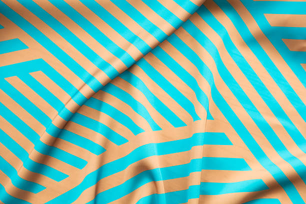 istock Colorful abstract fabric with geometric patterns in blue and orange tones draped elegantly 2237187933