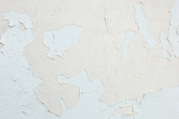 istock Peeling paint reveals layers of texture on a weathered wall in soft tones 2237188033