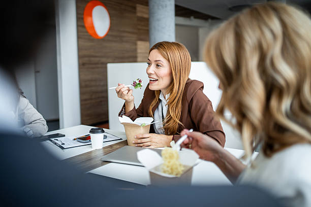 istock Business colleagues eating lunch together in office 2237188130