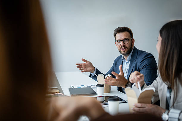istock Business people having working lunch in office 2237188228