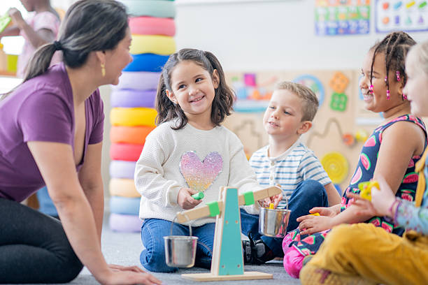 istock Friendly Classroom Scene With Diverse Kids Playing With Balancing Scale And Colorful Blocks 2237189545