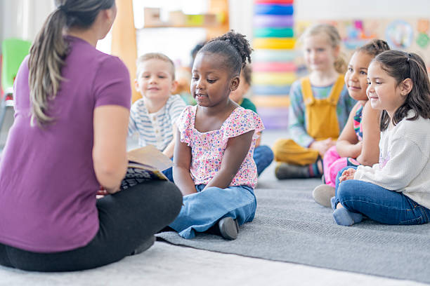 istock Diverse Classroom Reading Circle With Female Teacher Engaged Students In Bright Learning Space 2237189606