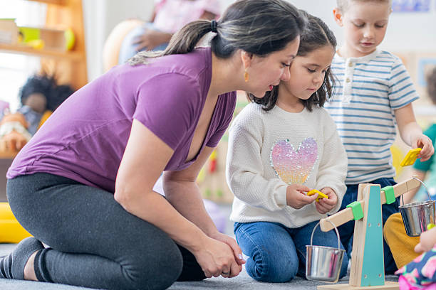 istock Caring Mom and Children Engage in Hands-On Learning With Balance Scale in Classroom 2237189619
