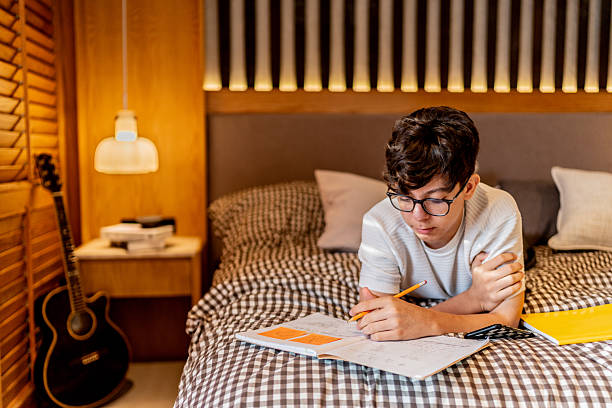 istock Teenage boy studying at home 2237192998