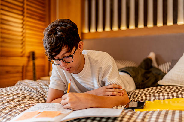 istock Teenage boy studying at home 2237193015