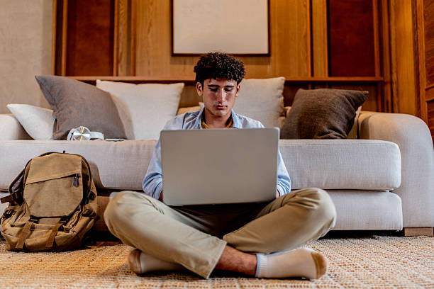 istock Teenage boy using laptop at home 2237193061