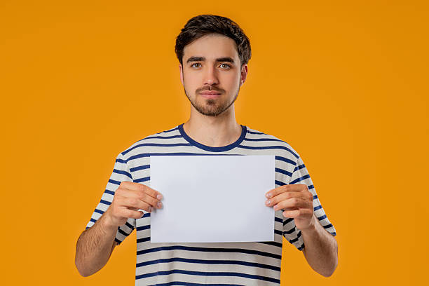 istock Serious man Holding Horizontal White A4 Paper Poster. Copy Space. Mock-Up Banner 2237194750